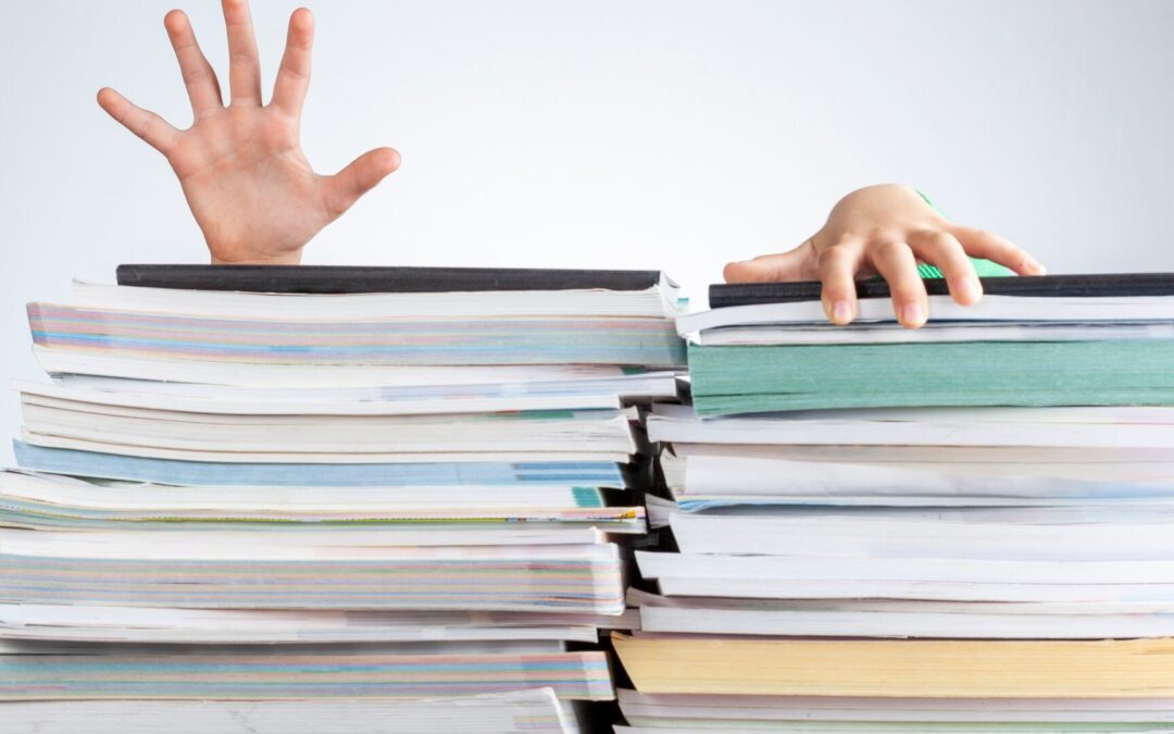 piles of paper with two extending from top